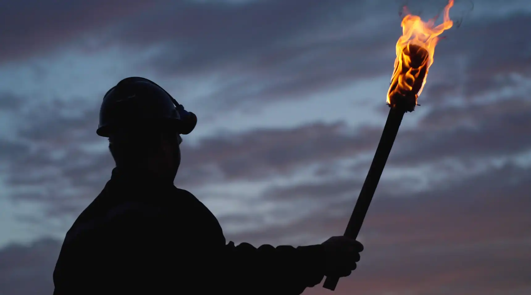 工人举火把前行